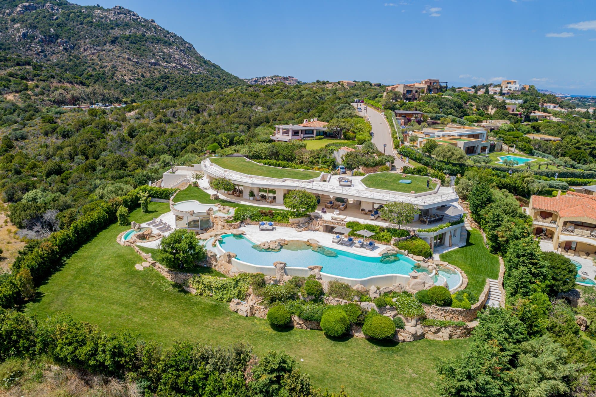 Sculpted hillside estate with rock pools — view 2