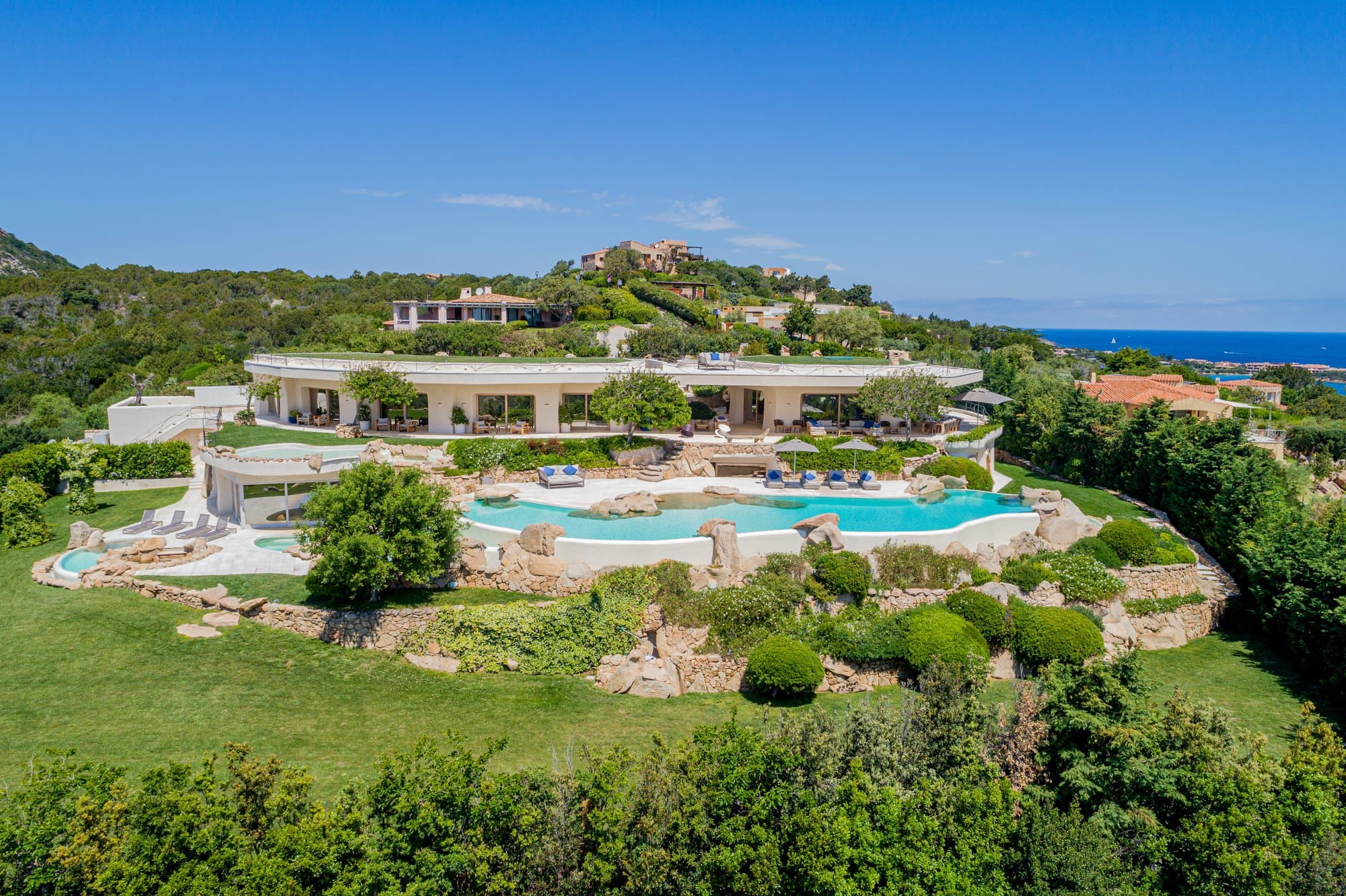 Sculpted hillside estate with rock pools — view 3